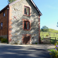 Charming stone holiday cottage in Mid Wales with a garden, surrounded by rolling countryside